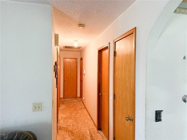 291 S Industrial Park Rd, Prairie Grove, AR 72753 - corridor with a textured ceiling and light colored carpet