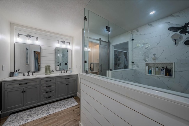 6 Muker Ln, Bella Vista, AR 72714 - bathroom featuring a marble finish shower, double vanity, and wood finished floors