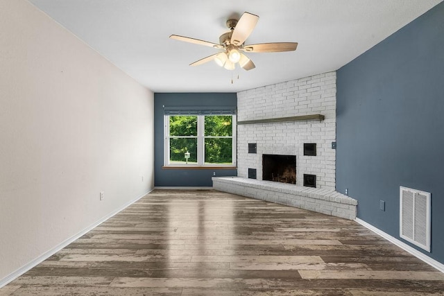 10 Magrath Ln, Bella Vista, AR 72715 - unfurnished living room featuring ceiling fan, wood finished floors, a fireplace, and baseboards