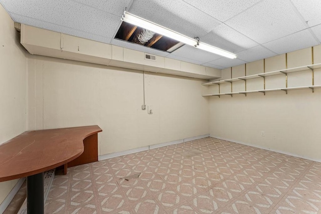 10 Magrath Ln, Bella Vista, AR 72715 - finished below grade area featuring a paneled ceiling, light floors, and baseboards