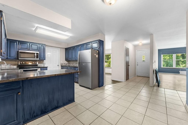 10 Magrath Ln, Bella Vista, AR 72715 - kitchen with appliances with stainless steel finishes, blue cabinetry, and dark countertops
