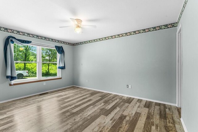 10 Magrath Ln, Bella Vista, AR 72715 - empty room with wood finished floors, ceiling fan, and baseboards