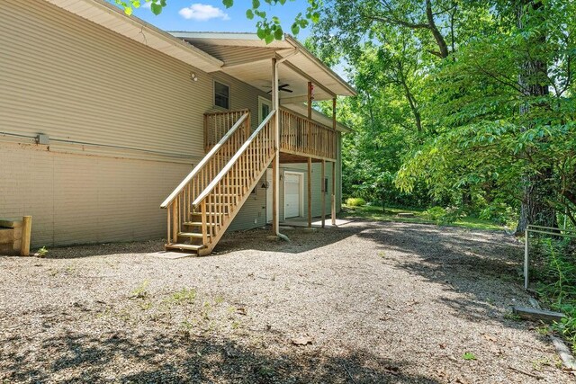 10 Magrath Ln, Bella Vista, AR 72715 - back of property with ceiling fan, stairs, and a wooden deck