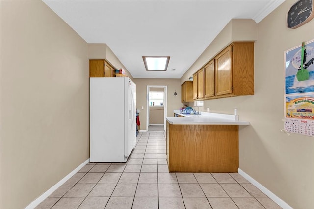 802 Buford St, Springdale, AR 72762 - kitchen with white refrigerator with ice dispenser, light countertops, a peninsula, light tile patterned flooring, and brown cabinets
