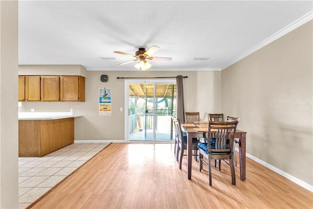 802 Buford St, Springdale, AR 72762 - dining room featuring ceiling fan, baseboards, light wood-style floors, ornamental molding, and a textured ceiling