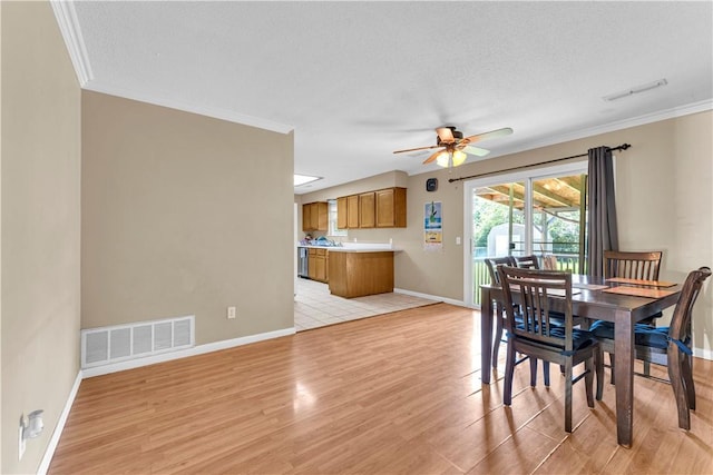802 Buford St, Springdale, AR 72762 - dining space with light wood-style flooring, ornamental molding, ceiling fan, baseboards, and a textured ceiling