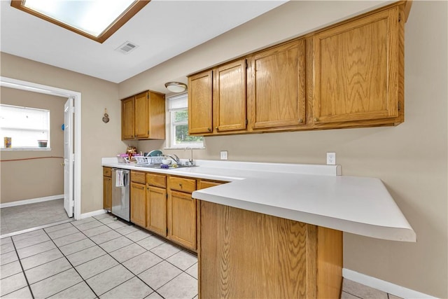 802 Buford St, Springdale, AR 72762 - kitchen with dishwasher, light countertops, brown cabinets, light tile patterned flooring, and a peninsula
