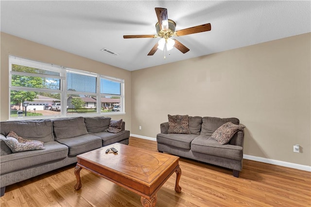 802 Buford St, Springdale, AR 72762 - living area featuring light wood-style floors, healthy amount of natural light, and a ceiling fan
