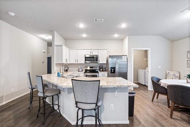 2213 E Fennec St, Siloam Springs, AR 72761 - kitchen featuring appliances with stainless steel finishes, washer and clothes dryer, a sink, dark wood-type flooring, and recessed lighting