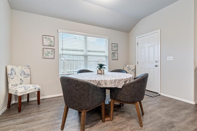 2213 E Fennec St, Siloam Springs, AR 72761 - dining room with light wood-style flooring, baseboards, and vaulted ceiling