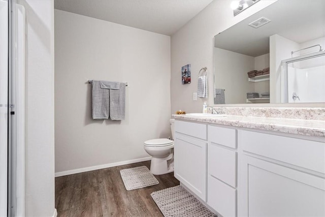 2213 E Fennec St, Siloam Springs, AR 72761 - full bath featuring wood finished floors, vanity, a shower with door, toilet, and baseboards