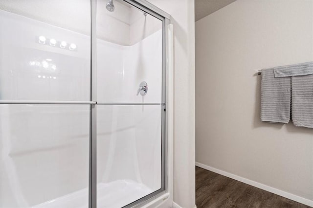 2213 E Fennec St, Siloam Springs, AR 72761 - bathroom with a stall shower, baseboards, and wood finished floors