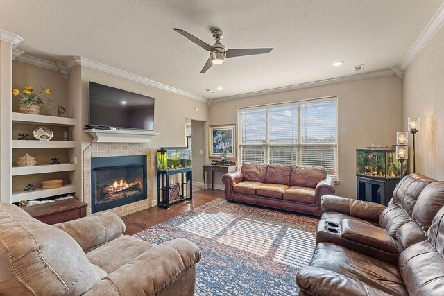 5703 S 66th St, Cave Springs, AR 72718 - living area with ceiling fan, wood finished floors, ornamental molding, a warm lit fireplace, and recessed lighting