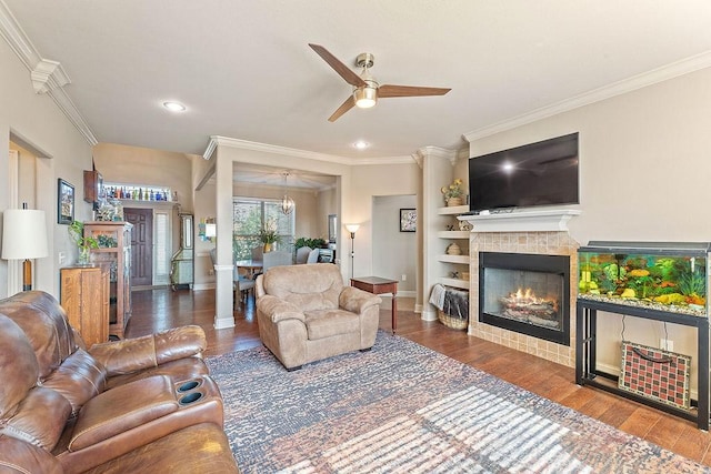 5703 S 66th St, Cave Springs, AR 72718 - living room with a ceiling fan, ornamental molding, a tiled fireplace, wood finished floors, and recessed lighting
