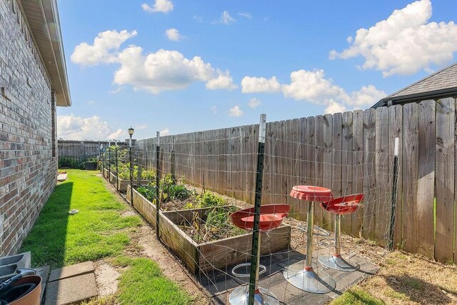 5703 S 66th St, Cave Springs, AR 72718 - fenced backyard featuring a vegetable garden