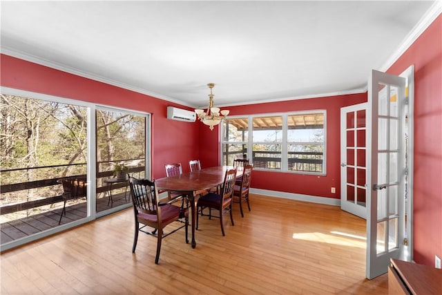 11021 Lathams Landing Rd, Garfield, AR 72732 - dining room featuring a wall mounted air conditioner, a chandelier, crown molding, wood-type flooring, and baseboards