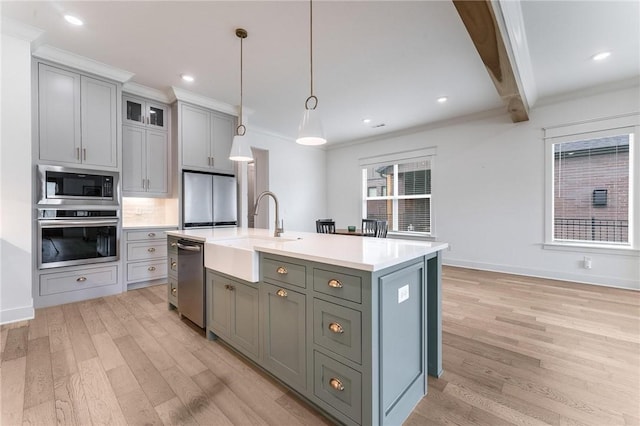 6741 Garden Trail Ave, Springdale, AR 72762 - kitchen featuring appliances with stainless steel finishes, light wood-style floors, light countertops, gray cabinetry, and decorative light fixtures