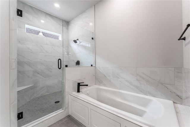 6741 Garden Trail Ave, Springdale, AR 72762 - bathroom with a bath, a stall shower, and tile patterned flooring