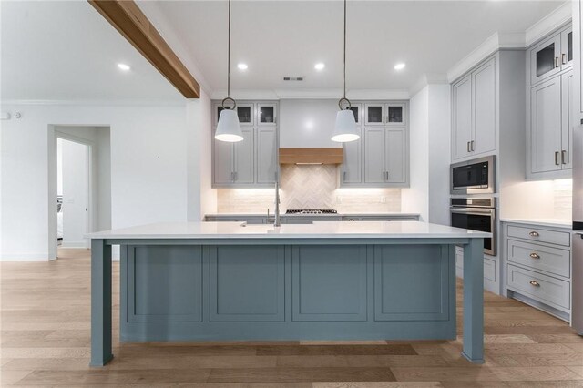 6741 Garden Trail Ave, Springdale, AR 72762 - kitchen featuring stainless steel appliances, light countertops, an island with sink, decorative backsplash, and ornamental molding