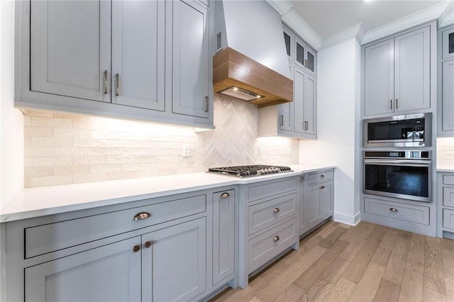 6741 Garden Trail Ave, Springdale, AR 72762 - kitchen featuring appliances with stainless steel finishes, custom exhaust hood, gray cabinetry, and ornamental molding