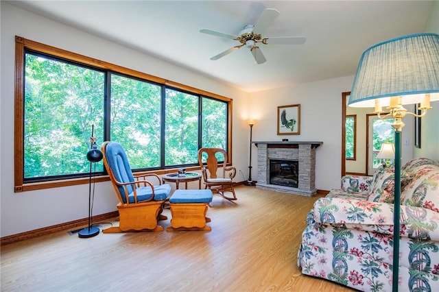 19 Bobwhite Ln, Holiday Island, AR 72631 - living room featuring plenty of natural light, wood finished floors, a fireplace, and ceiling fan