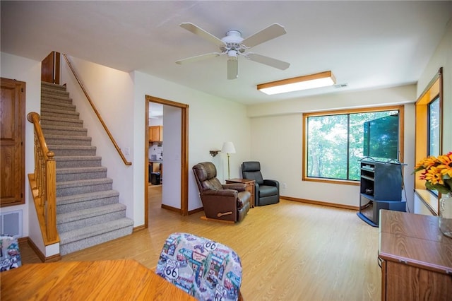 19 Bobwhite Ln, Holiday Island, AR 72631 - living room with light wood-style floors, stairway, and a ceiling fan