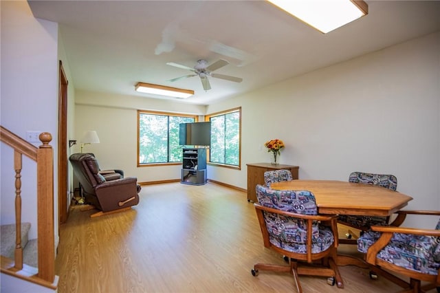19 Bobwhite Ln, Holiday Island, AR 72631 - dining space featuring light wood-style floors, a ceiling fan, and stairway