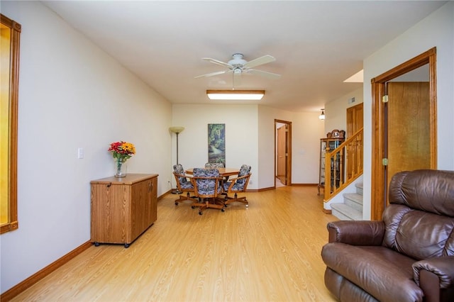 19 Bobwhite Ln, Holiday Island, AR 72631 - dining room featuring light wood finished floors, stairs, and a ceiling fan