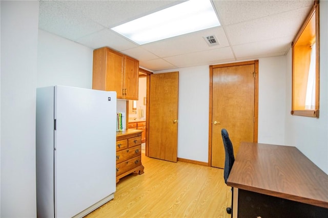 19 Bobwhite Ln, Holiday Island, AR 72631 - kitchen featuring freestanding refrigerator, light wood-style floors, and a paneled ceiling