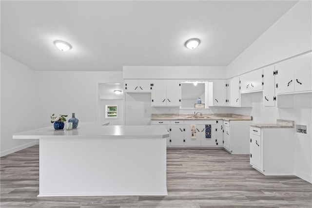 308 Kane St, Siloam Springs, AR 72761 - kitchen with white cabinets, light wood finished floors, light countertops, and lofted ceiling