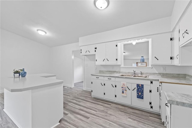 308 Kane St, Siloam Springs, AR 72761 - kitchen with light countertops, white cabinetry, and light wood-style flooring