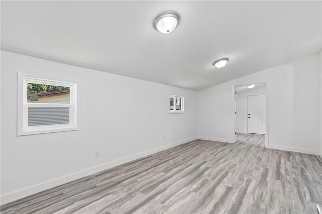 308 Kane St, Siloam Springs, AR 72761 - empty room featuring light wood-type flooring and vaulted ceiling