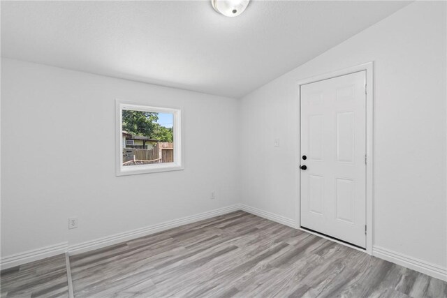 308 Kane St, Siloam Springs, AR 72761 - unfurnished room featuring vaulted ceiling and wood finished floors