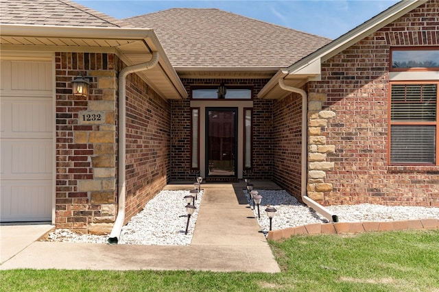 1232 Big Oak Dr, Alma, AR 72921 - view of exterior entry featuring a shingled roof, brick siding, and an attached garage