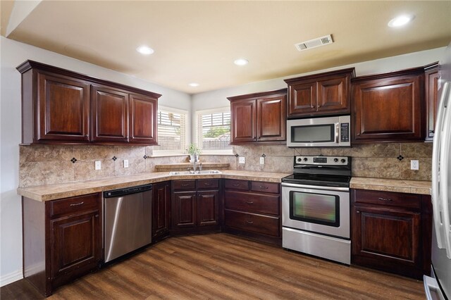 1232 Big Oak Dr, Alma, AR 72921 - kitchen with stainless steel appliances, dark wood finished floors, dark brown cabinets, and recessed lighting