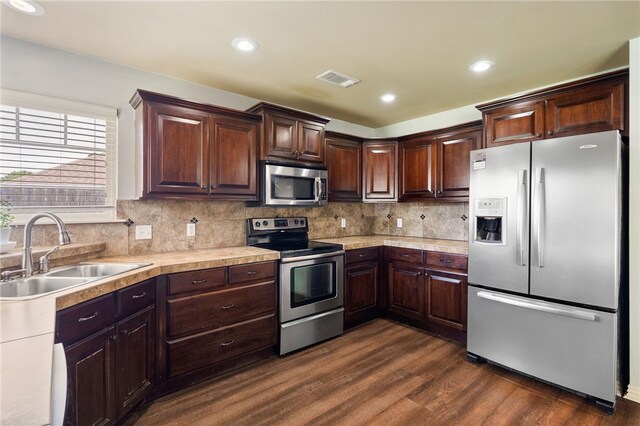 1232 Big Oak Dr, Alma, AR 72921 - kitchen with stainless steel appliances, light countertops, dark wood finished floors, dark brown cabinets, and backsplash