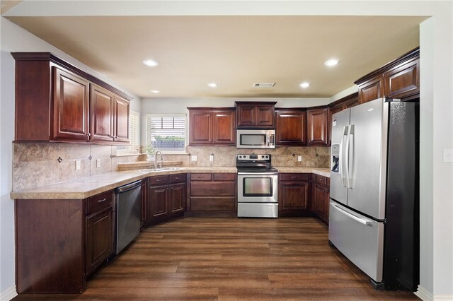1232 Big Oak Dr, Alma, AR 72921 - kitchen with stainless steel appliances, dark wood-style floors, light countertops, tasteful backsplash, and recessed lighting