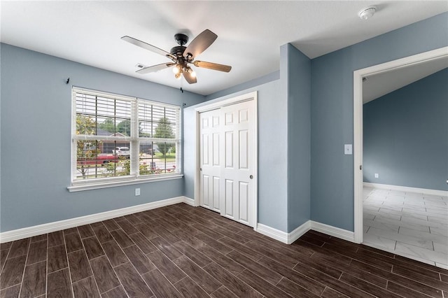 3530 Reynolds Ave, Springdale, AR 72764 - unfurnished bedroom featuring a closet, a ceiling fan, and dark wood-style flooring