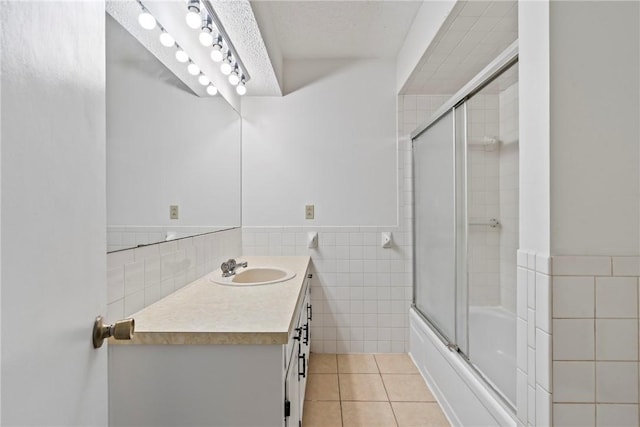 50233 S 725th Rd, Colcord, OK 74338 - bathroom with tile walls, vanity, tile patterned flooring, shower / bath combination with glass door, and a wainscoted wall