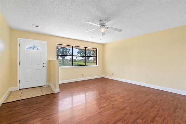 50233 S 725th Rd, Colcord, OK 74338 - entrance foyer featuring wood finished floors, ceiling fan, and a textured ceiling