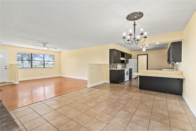50233 S 725th Rd, Colcord, OK 74338 - kitchen featuring white appliances, light tile patterned floors, ceiling fan, light countertops, and a chandelier