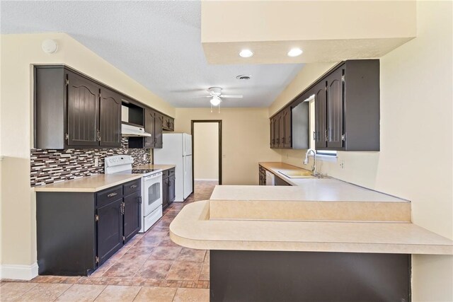 50233 S 725th Rd, Colcord, OK 74338 - kitchen featuring white appliances, under cabinet range hood, decorative backsplash, a ceiling fan, and light countertops
