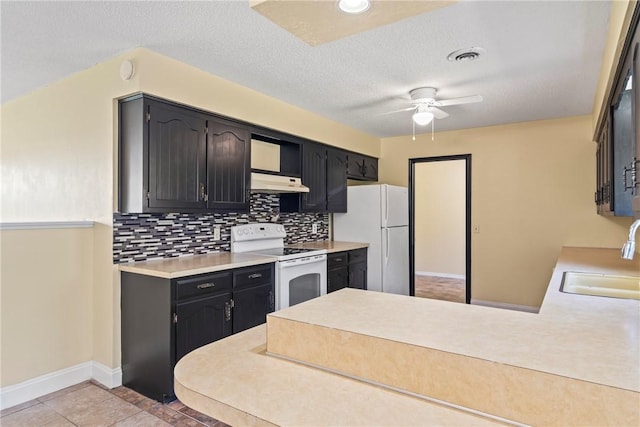 50233 S 725th Rd, Colcord, OK 74338 - kitchen with white appliances, under cabinet range hood, ceiling fan, tasteful backsplash, and a peninsula