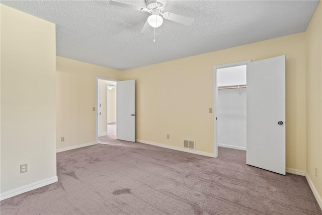 50233 S 725th Rd, Colcord, OK 74338 - unfurnished bedroom with carpet flooring, a textured ceiling, a ceiling fan, and a spacious closet