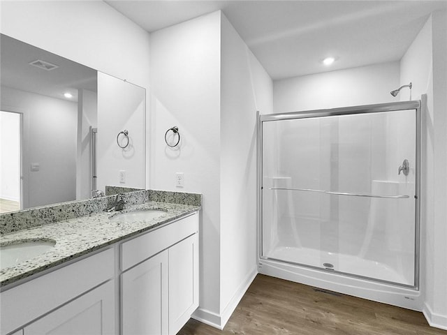 960 Hudson St, Prairie Grove, AR 72753 - bathroom with wood finished floors, double vanity, a stall shower, and recessed lighting