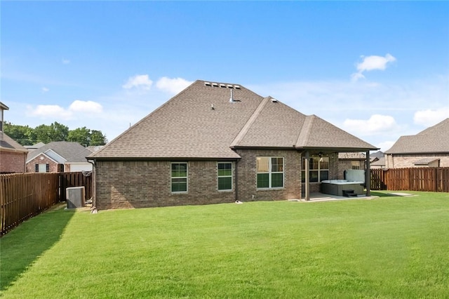 1511 Aniston Rd, Centerton, AR 72719 - rear view of house with a hot tub, a fenced backyard, brick siding, a patio, and a shingled roof