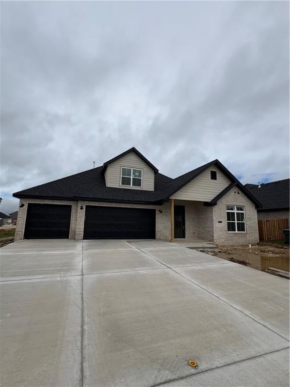 1309 Carrara, Tontitown, AR 72762 - view of front of property with driveway, a shingled roof, an attached garage, and a garage