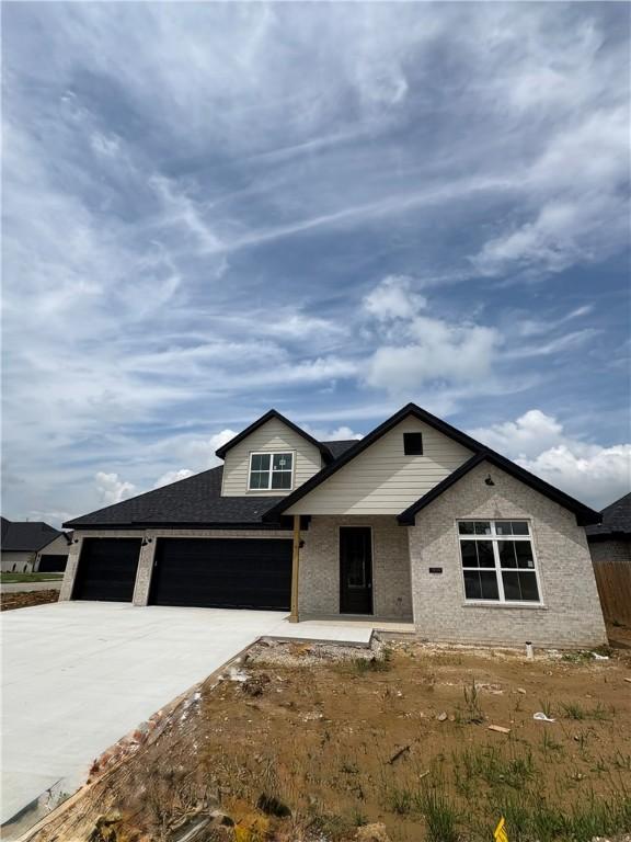 1309 Carrara, Tontitown, AR 72762 - view of front of home with driveway and a garage