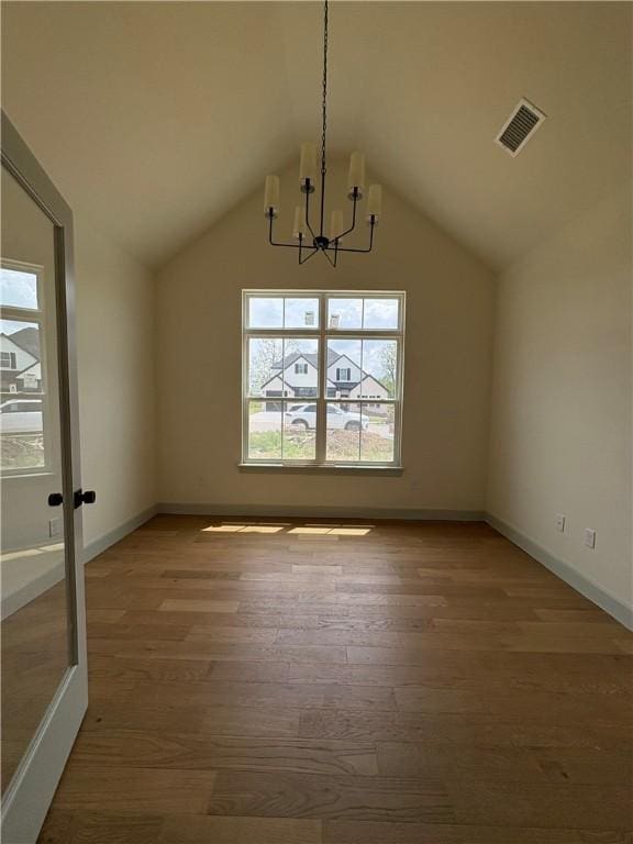 1309 Carrara, Tontitown, AR 72762 - unfurnished dining area featuring a chandelier, wood finished floors, and vaulted ceiling