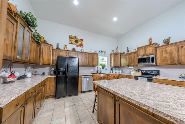 19959 Rheas Community Rd, Lincoln, AR 72744 - kitchen featuring black appliances, light countertops, light tile patterned floors, recessed lighting, and glass insert cabinets
